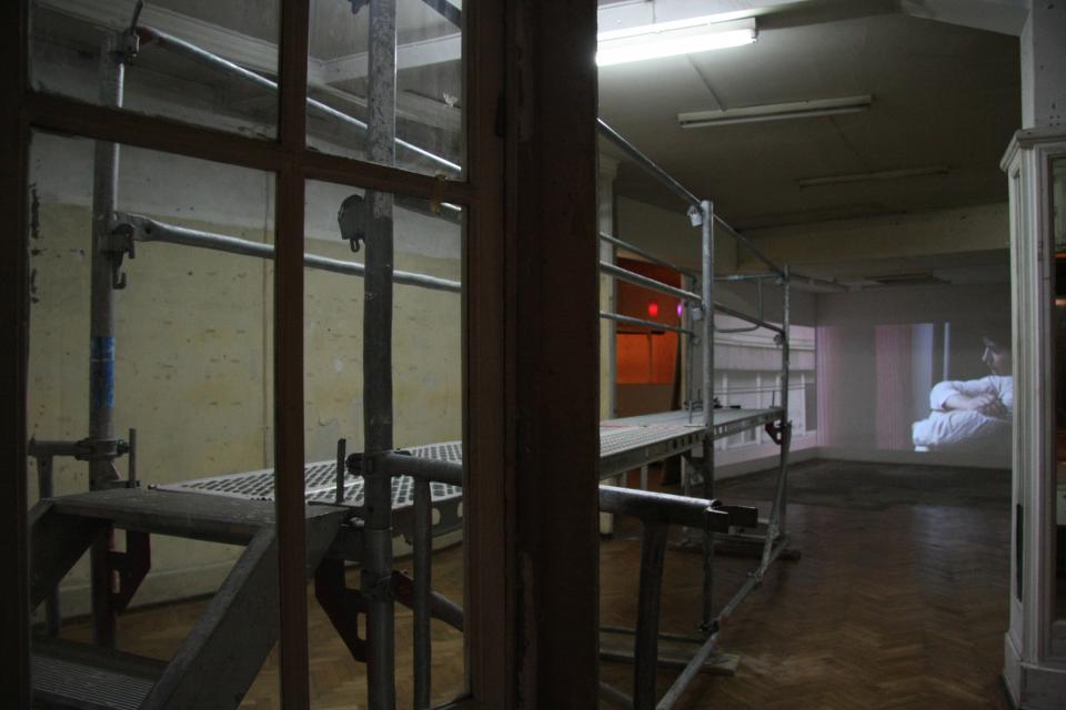 installation view of scaffolding and video installation