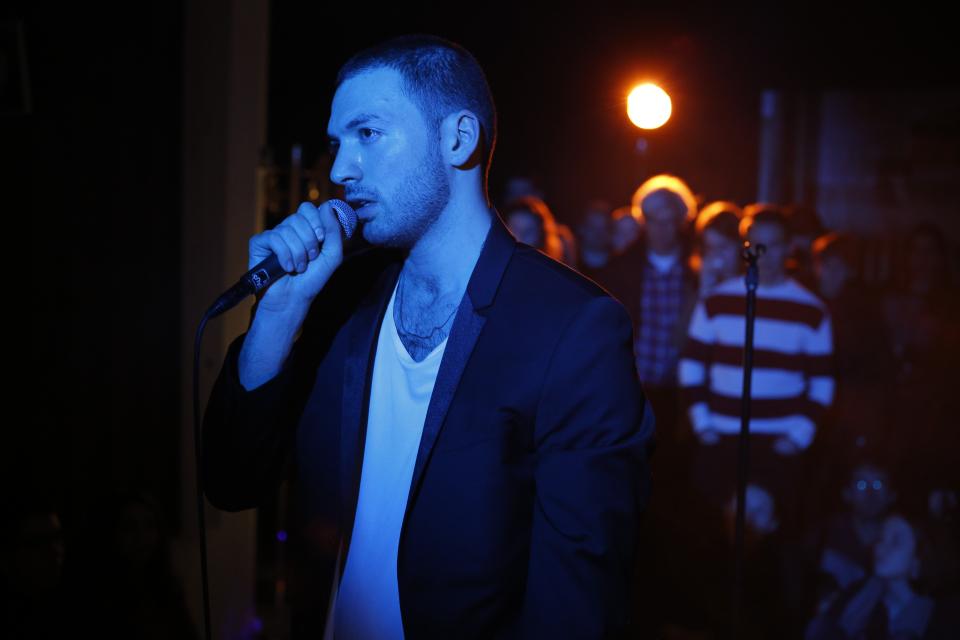 artist speaking into microphone